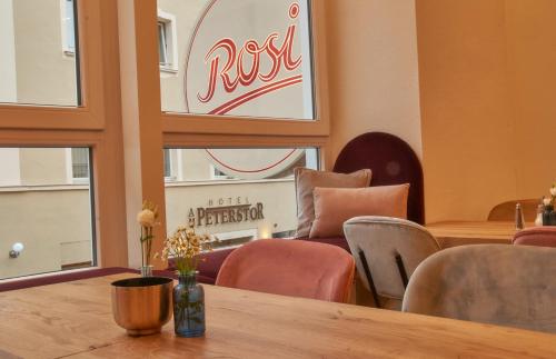 a restaurant with a table and chairs and a sign at Rosi Boutique Hotel in Regensburg