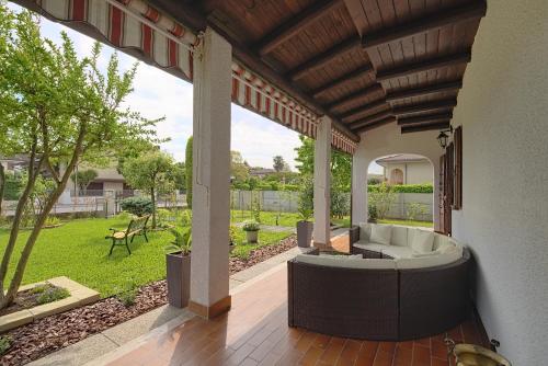 a porch with a bath tub on a patio at VECCHIA FAVOLA HOUSE in Quarto dʼAltino