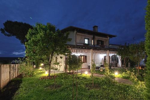 a house with lights in the yard at night at VECCHIA FAVOLA HOUSE in Quarto dʼAltino
