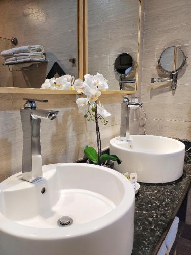 a bathroom with a sink and a flower on a counter at Weston Suites Hotel in Santo Domingo