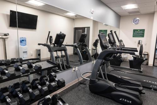 a gym with tread machines and a mirror at Wingate by Wyndham Angola in Angola