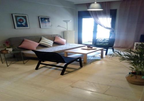 a living room with a couch and a table at Karditsa Home Sweet Home 80 τ.μ in Kardítsa