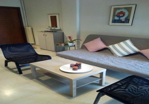 a living room with a couch and a table at Karditsa Home Sweet Home 80 τ.μ in Kardítsa