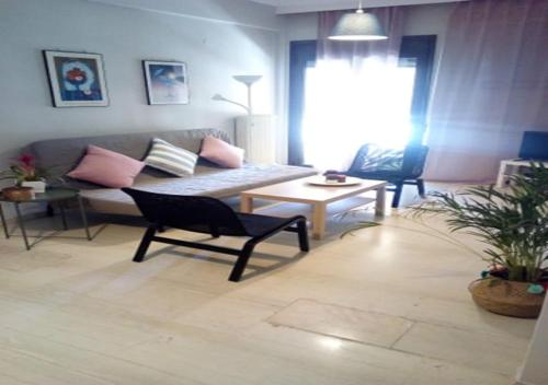 a living room with a couch and a table at Karditsa Home Sweet Home 80 τ.μ in Kardítsa