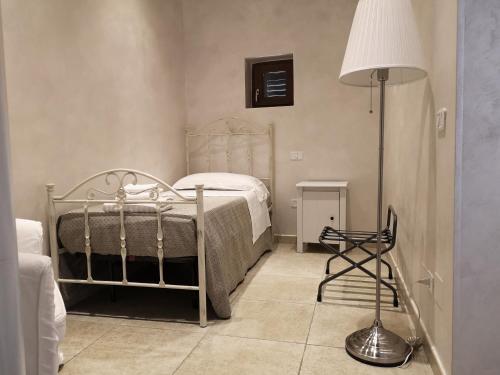 Ένα ή περισσότερα κρεβάτια σε δωμάτιο στο Relais La Pretura