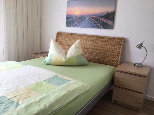 a bedroom with a bed and a night stand with a lamp at Ferienhaus Am Yachthafen in Rendsburg