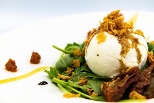 a plate of food on a white plate at Hotel & Spa Princesa Munia in Oviedo