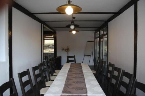 a long table and chairs in a room at Franzdorf Alpin in Văliug