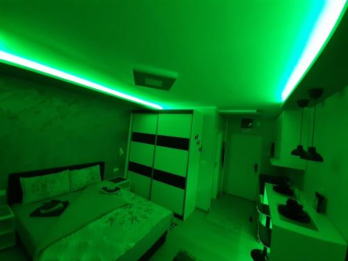 a green light in a bedroom with a bed at Victoria in Vračar (historical)