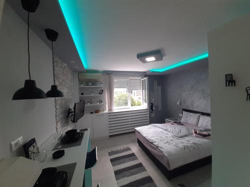 a bedroom with a bed and a blue light at Victoria in Vračar (historical)