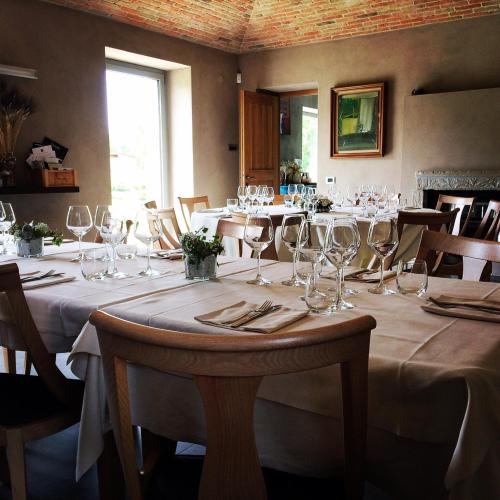 a dining room with tables with wine glasses at Agriresort Villa Gelso- Adults Friendly in Vesime