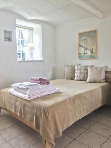 a bedroom with a bed with towels on it at Brunbjerg Apartments in Billund