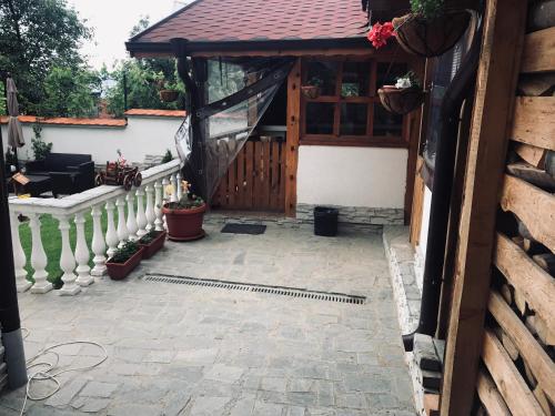 a porch of a house with a pavilion with a fence at Guest house Grahlyov in Sapareva Banya