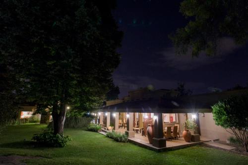 a house at night with lights in the yard at Casa La Galeana - Eco Boutique in Chacras de Coria