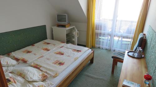 Postel nebo postele na pokoji v ubytování Prima Porta Vendeghaz
