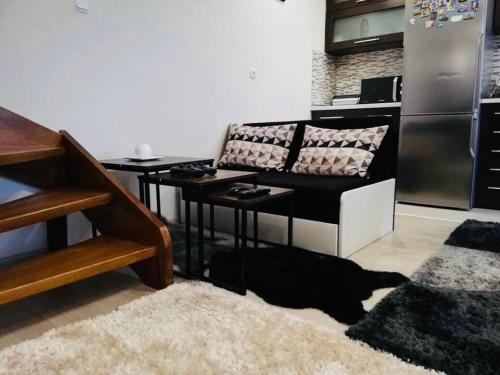 a black dog laying on the floor in a kitchen at Guest house Grahlyov in Sapareva Banya