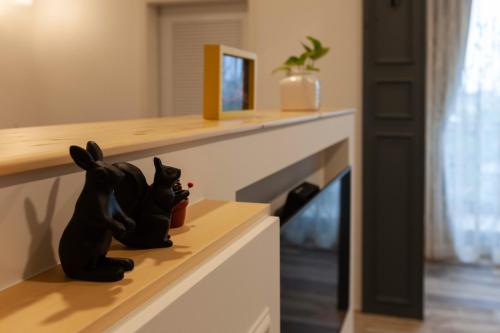 a figurine of a black cat sitting on a drawer at Rambling Snail in Luodong