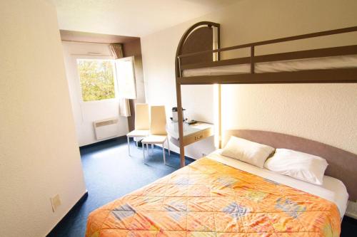a bedroom with a bunk bed and a desk at EGG HOTEL - HOTEL LES GENS DE MER Dieppe in Dieppe