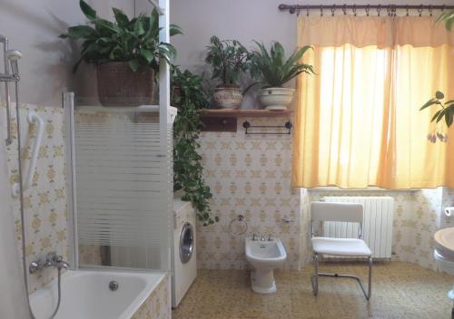 a bathroom with a tub and a toilet and a sink at La Finestra sul Fiume in Fossombrone