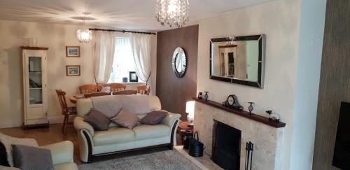 a living room with a couch and a fireplace at Comfy Quiet Town House in Strabane