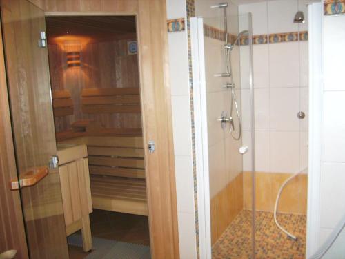 ein Badezimmer mit einer Dusche und einer Glasdusche an der Hintertür in der Unterkunft Landhaus Trinker in Schladming