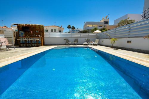 a large blue swimming pool on top of a building at Seafront Protaras Villas in Protaras