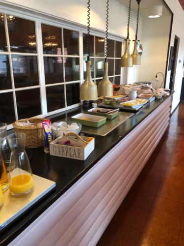 a buffet line with food on display in a restaurant at Yxnerum Hotell in Yxnerum