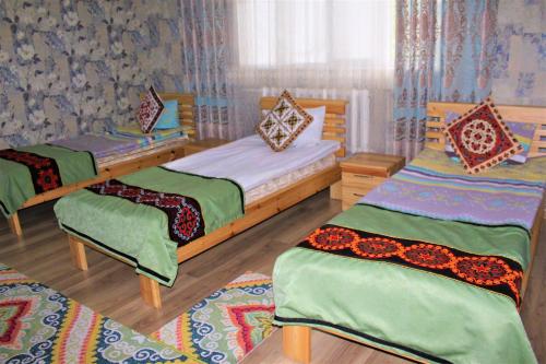 a bedroom with two beds at Guest House EtnoDom in Jalal-Abad