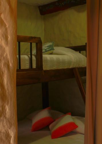 a bunk bed with two pillows in a room at Casa Encuentro Ecolodge, Outdoor Gym and Yoga in Guatapé