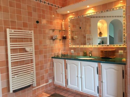 a bathroom with a sink and a mirror at Appartements Les Pesquiers 2 Hyères Plage in Hyères