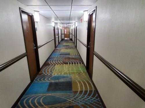 a long corridor with paintings on the floors of a building at Best Western Adena Inn in Chillicothe
