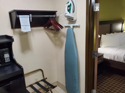 a hotel room with a bed and a blue surfboard on the wall at Best Western Adena Inn in Chillicothe