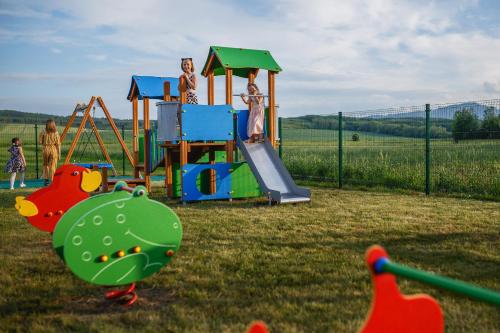 a group of children playing on a playground at Biała Akacja Resort & Business in Prudnik