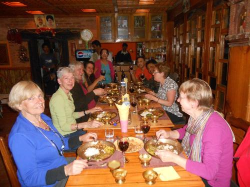 a group of people sitting at a table in a restaurant at Shiva Guest House in Bhaktapur