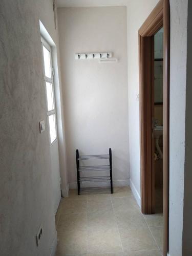 an empty hallway with a bench in a room at Sweet Dream Rooms in Podgorica