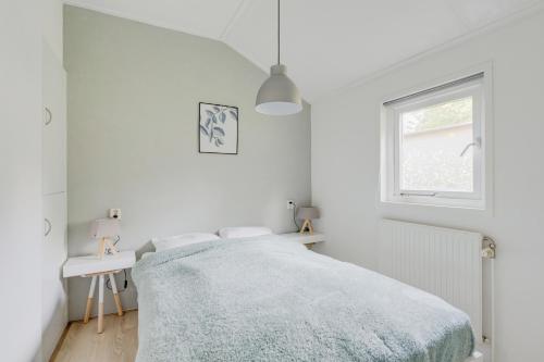 Een bed of bedden in een kamer bij Chalet Descansar op de Veluwe