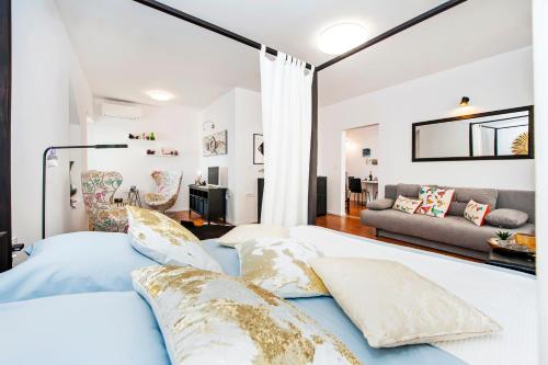 a bedroom with a bed and a living room at Apartments Sea View - Sunrise and Maremonte in Rovinj