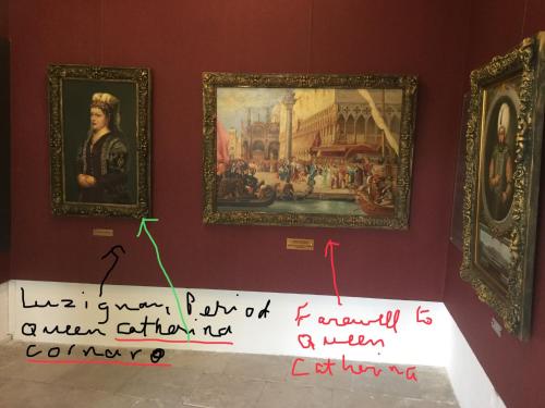 a sign in a museum with two paintings on a wall at Aphrodite Beachfront Apartment in Ghaziveran