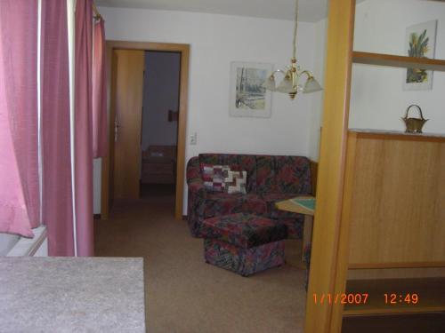 a living room with a couch and a chair at Ferienhäuser Thalbach in Heiligenblut