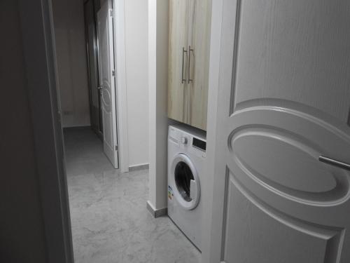 a laundry room with a washer and dryer in a bathroom at Alp Apartment in Mağusa