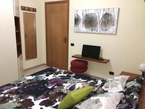 a bedroom with a bed and a laptop on a desk at La Casa del Sole in Marina di Pisticci
