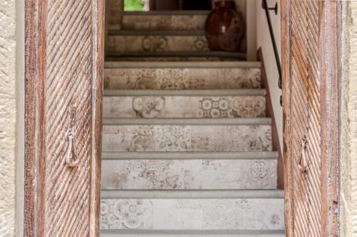 a set of stairs in a wooden cabinet with a door at Casa Bici in Chianni