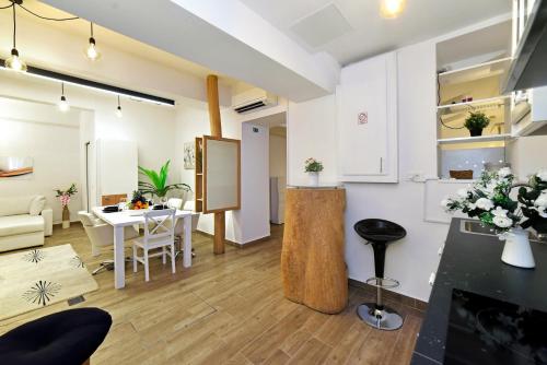 a kitchen and living room with a table and chairs at Ban Jelačić Apartment in Zagreb