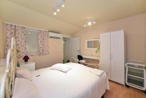 a bedroom with a large white bed and a desk at Ban Jelačić Apartment in Zagreb