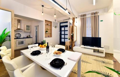 a living room with a white table and chairs at Ban Jelačić Apartment in Zagreb