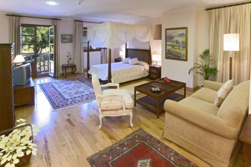 a bedroom with a bed and a living room at Posada Mar de Santillana in Ubiarco