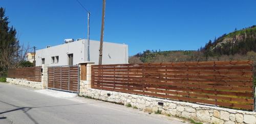 a wooden fence on the side of a road at Renaissance Modern Stone House at Vryses - Private pool in Vryses