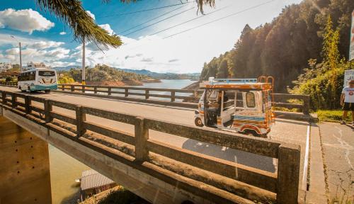 a truck driving down a road on a bridge at Casa Encuentro Ecolodge, Outdoor Gym and Yoga in Guatapé