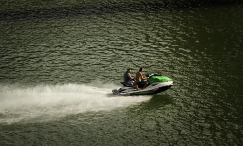 two people on a jet ski in the water at Casa Encuentro Ecolodge, Outdoor Gym and Yoga in Guatapé