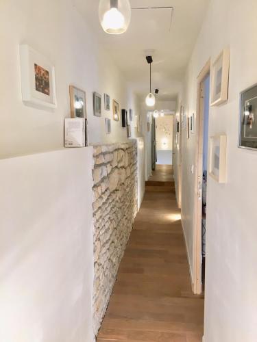 a hallway in a house with a stone wall at La maison des amis in Nuits